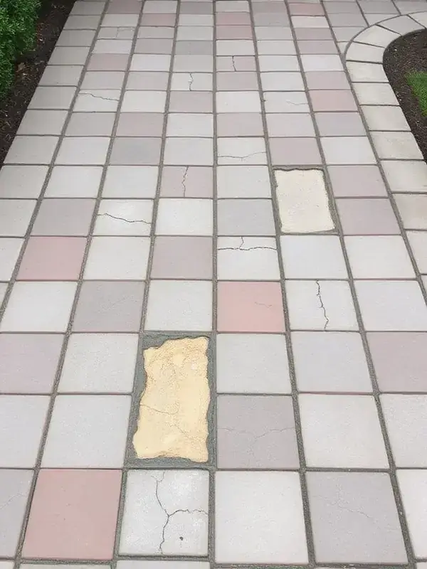 Settled and stained Estero paver patio before restoration
